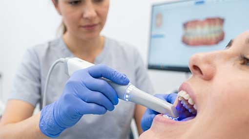 A clean, professional close-up showing the non-invasive digital scanning technology being used gently by a staff member.